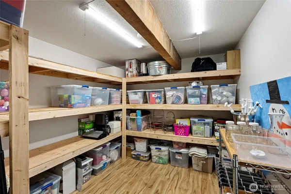 a utility room with stainless steel appliances lots of wooden furniture