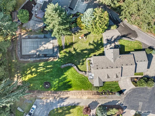 an aerial view of a house with a yard swimming pool