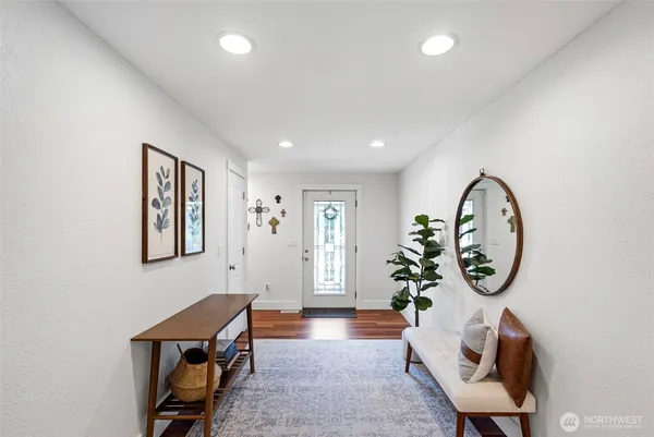 a living room with furniture a potted plant and a chair