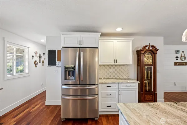a kitchen with stainless steel appliances granite countertop a refrigerator and a stove top oven