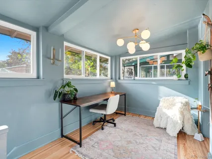 a view of a dining room with furniture and a chandelier