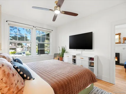 a bedroom with a bed and wooden floor