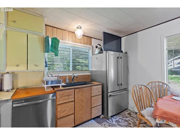a kitchen with stainless steel appliances a sink cabinets and a refrigerator