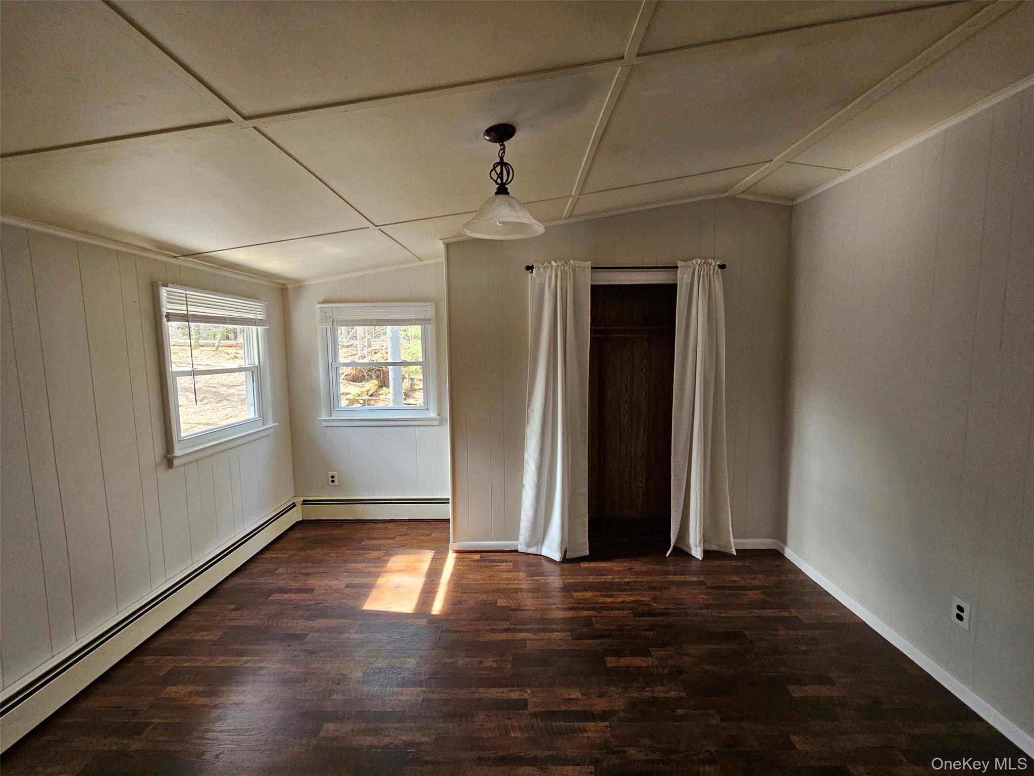 639 State Rte 55, Unit 2 Eldred, NY 12732 - Photo 8 of 11 an empty room with wooden floor and windows