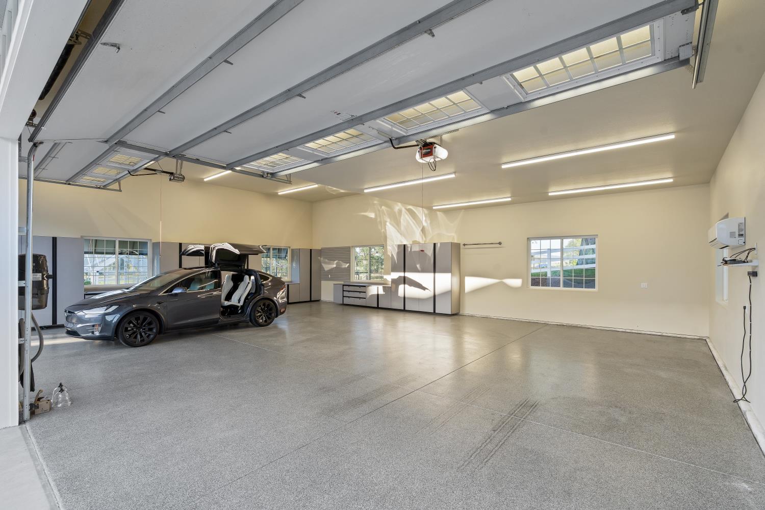 2905 Virginiatown Road Lincoln, CA 95648 - Photo 68 of 86 Spacious garage featuring an epoxy-coated concrete floor, ample overhead fluorescent lighting, and multiple windows providing natural light