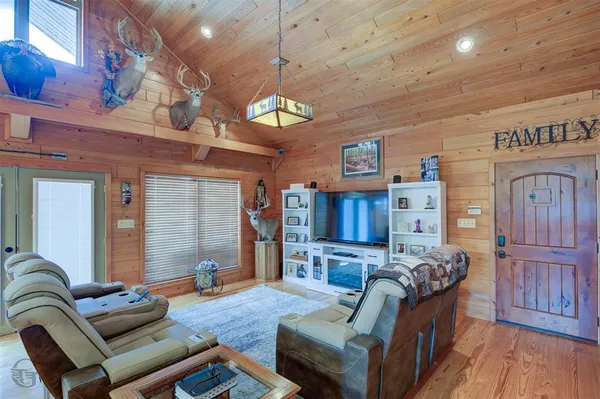 a living room with fireplace furniture and a flat screen tv