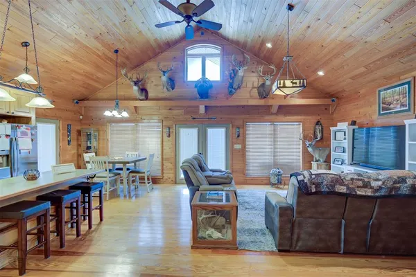 a living room with lots of furniture and kitchen view