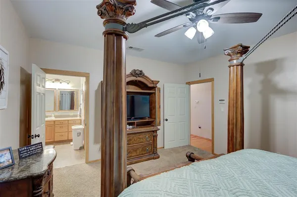 a bedroom with a bed and a chandelier