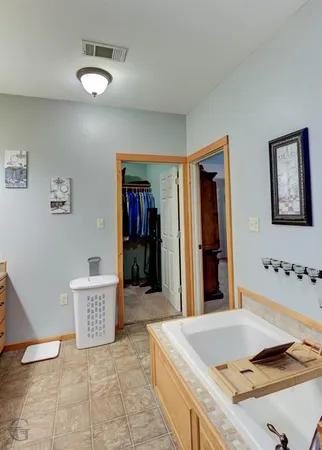 a spacious bathroom with a granite countertop sink and a mirror