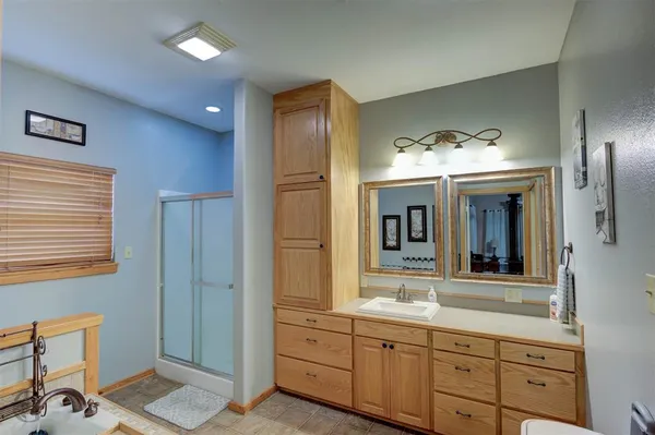 a view of a bathroom with dual sinks
