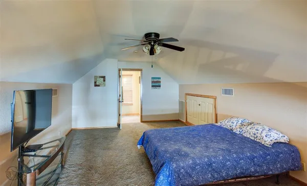 a bedroom with a bed and cabinets