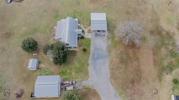an aerial view of a house with outdoor space