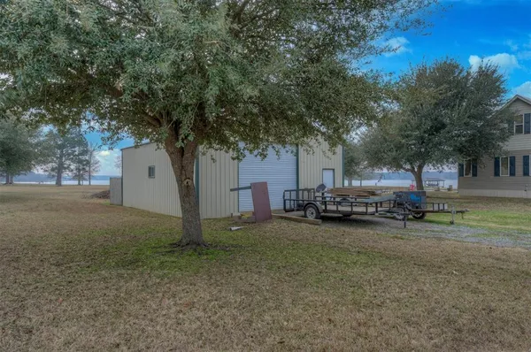a view of a house with a yard and tree s