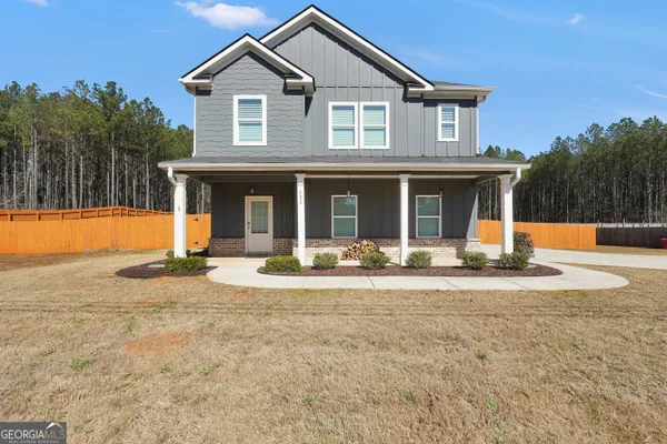 a front view of a house with yard and garage