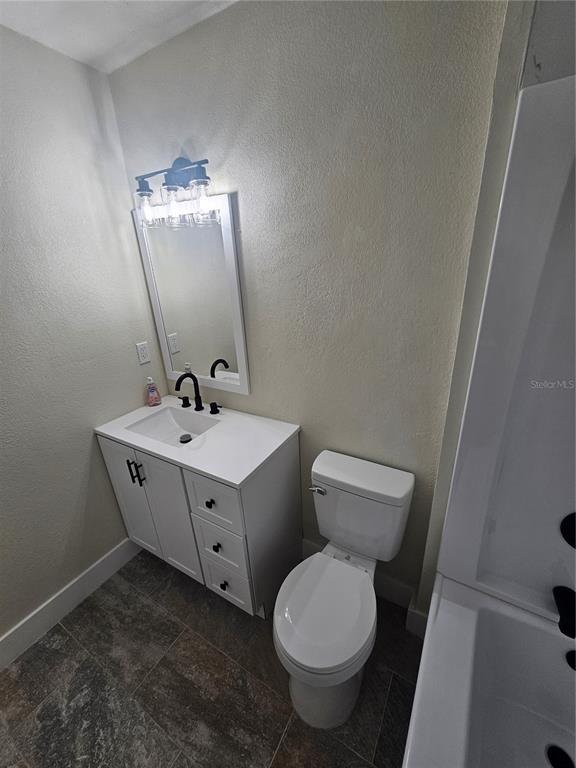 567 School Street Bronson, FL 32621 - Photo 16 of 23 a bathroom with a toilet sink and mirror