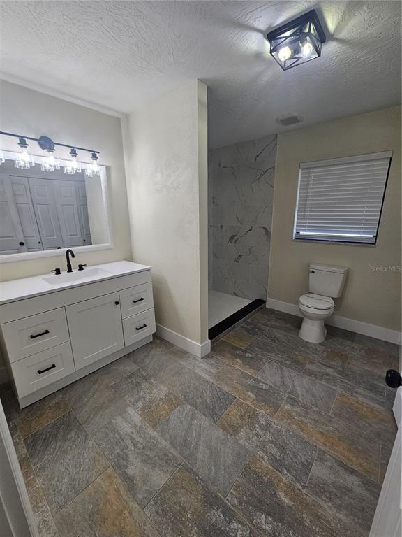 567 School Street Bronson, FL 32621 - Photo 19 of 23 a bathroom with a sink mirror and toilet