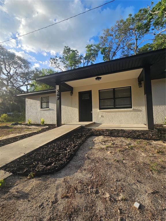 567 School Street Bronson, FL 32621 - Photo 4 of 23 a front view of a house with a yard and garage