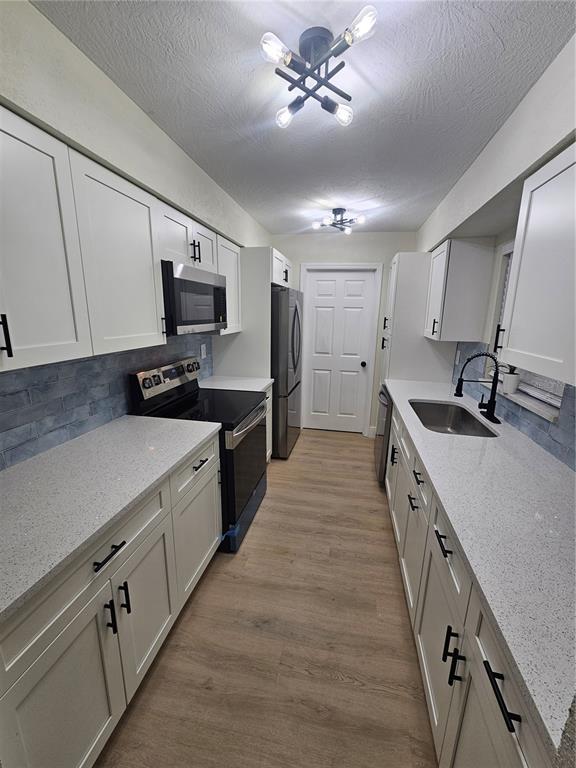 567 School Street Bronson, FL 32621 - Photo 9 of 23 a kitchen with granite countertop a sink appliances cabinets and a counter top space