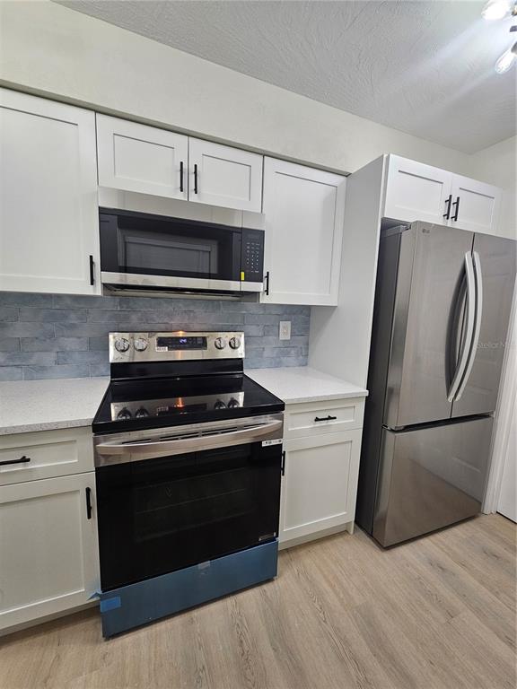 567 School Street Bronson, FL 32621 - Photo 10 of 23 a kitchen with a stove and a microwave