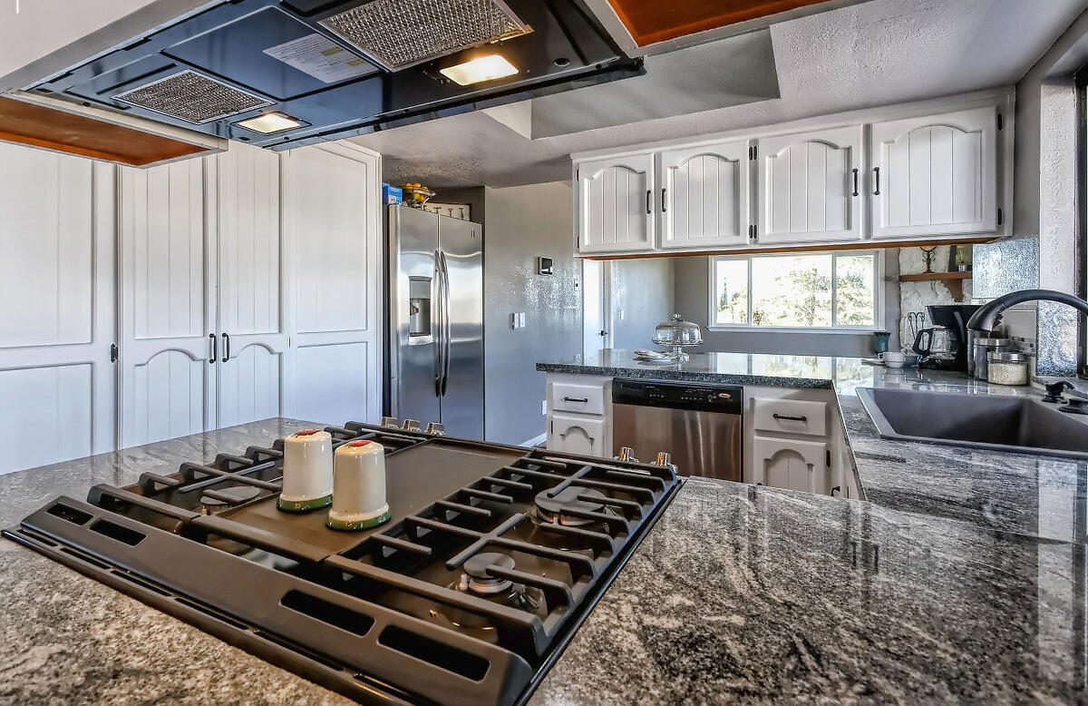 20140 Sahale Road Apple Valley, CA 92307 - Photo 22 of 45 a stove top oven sitting inside of a kitchen