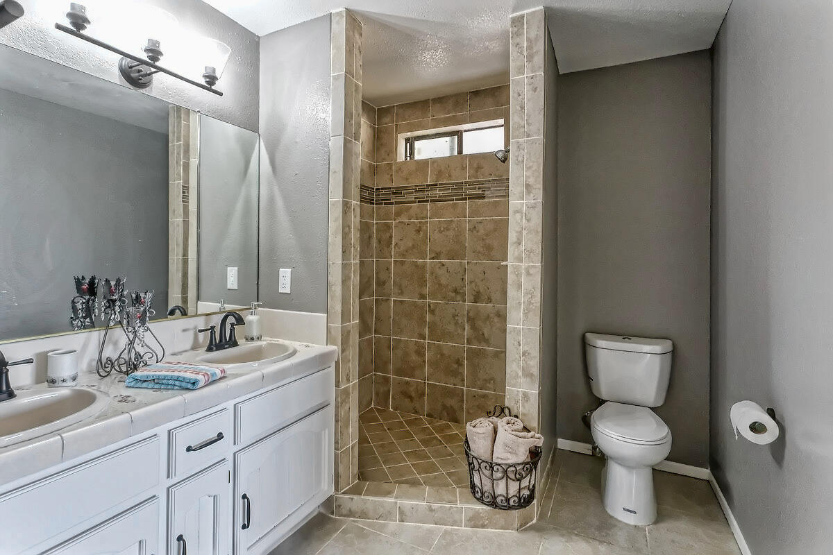 20140 Sahale Road Apple Valley, CA 92307 - Photo 39 of 45 a bathroom with a toilet sink and mirror
