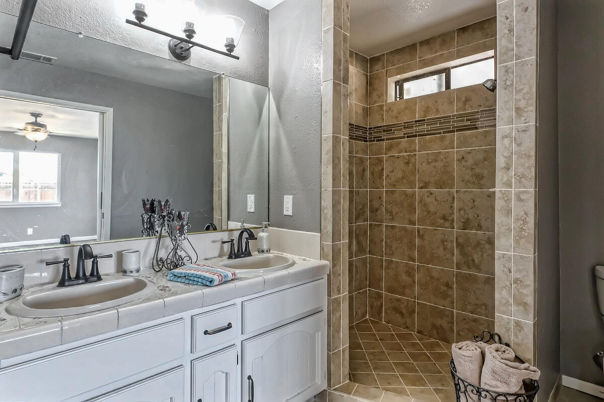 20140 Sahale Road Apple Valley, CA 92307 - Photo 40 of 45 a bathroom with a double vanity sink mirror and shower