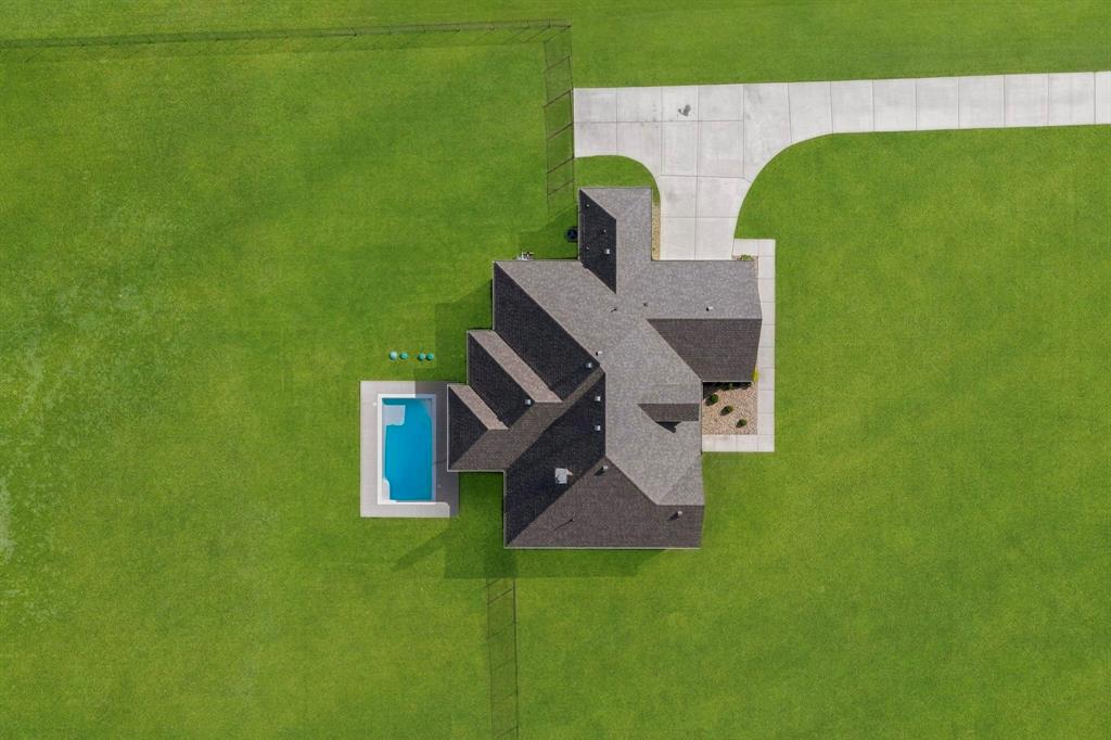 634 Gant Road Sherman, TX 75090 - Photo 3 of 40 Expansive green lawn surrounds a single-story residence with a multi-gabled roofline