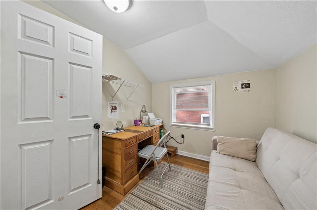 2106 Lindsay Road Pittsburgh, PA 15221 - Photo 25 of 36 The third bedroom can easily transition into a cozy den or office, where the compact space can be lined with built-in bookshelves, a small wooden desk, and a comfortable armchair placed near the window.