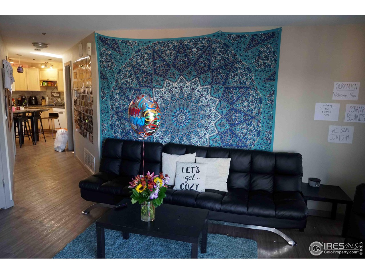 903 18th Street, Unit 302 Boulder, CO 80302 - Photo 2 of 10 a living room with furniture and flowers