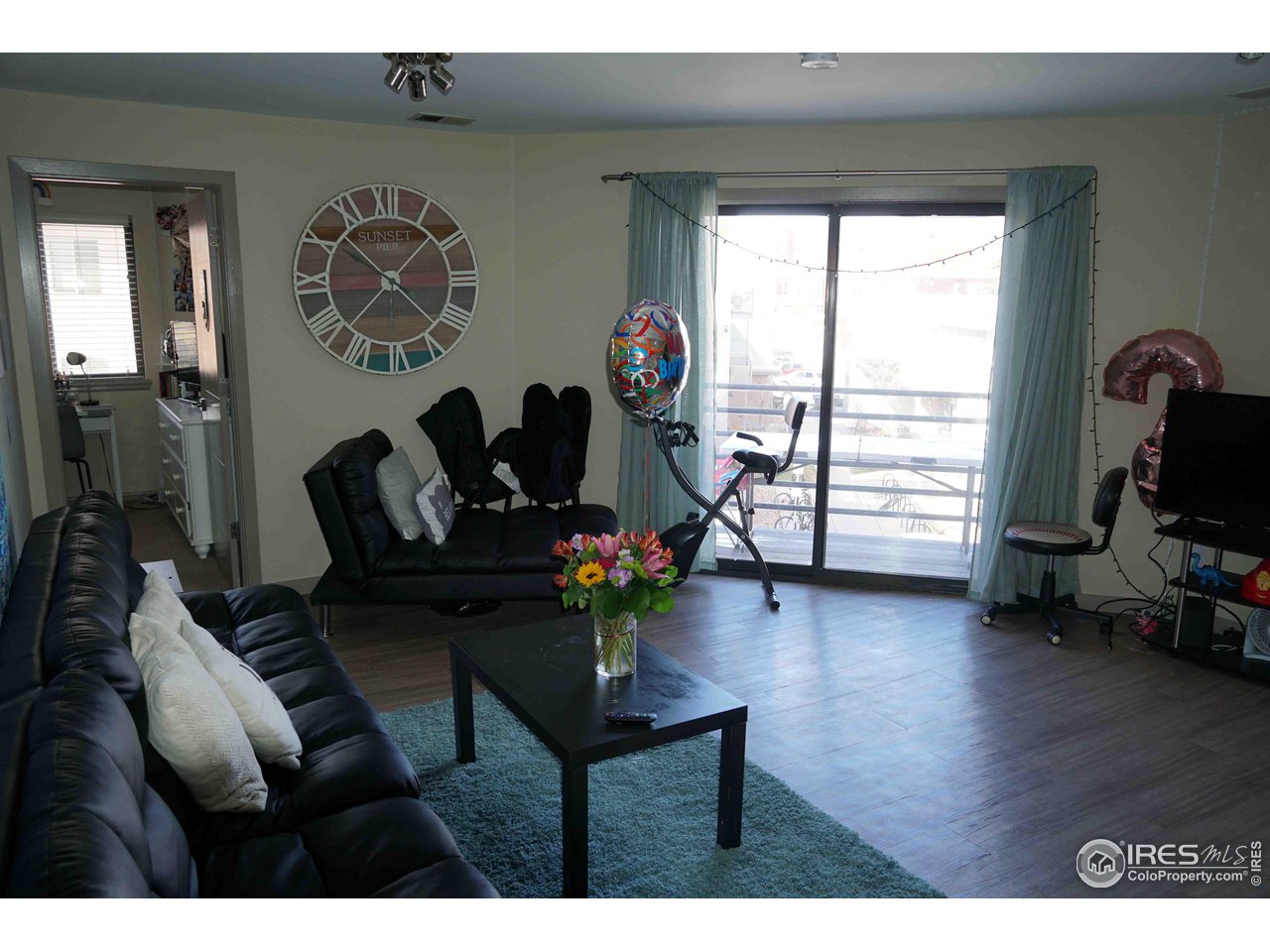 903 18th Street, Unit 302 Boulder, CO 80302 - Photo 3 of 10 a living room with furniture and wooden floor