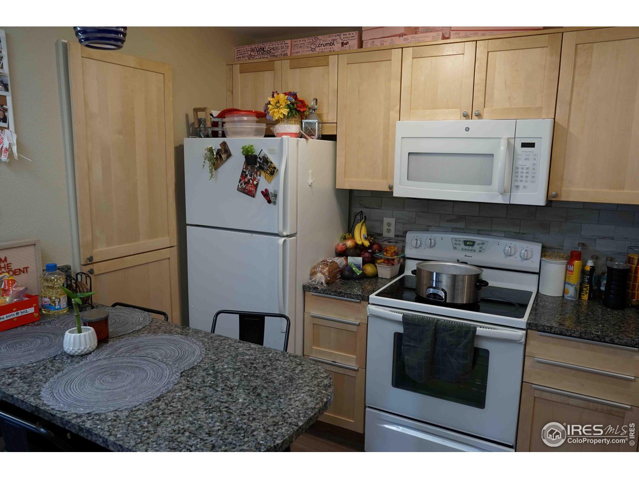 903 18th Street, Unit 302 Boulder, CO 80302 - Photo 5 of 10 a kitchen with a refrigerator and a sink