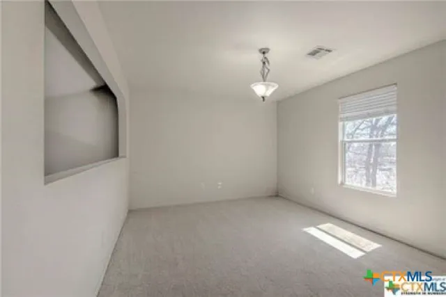 a view of an empty room with a window