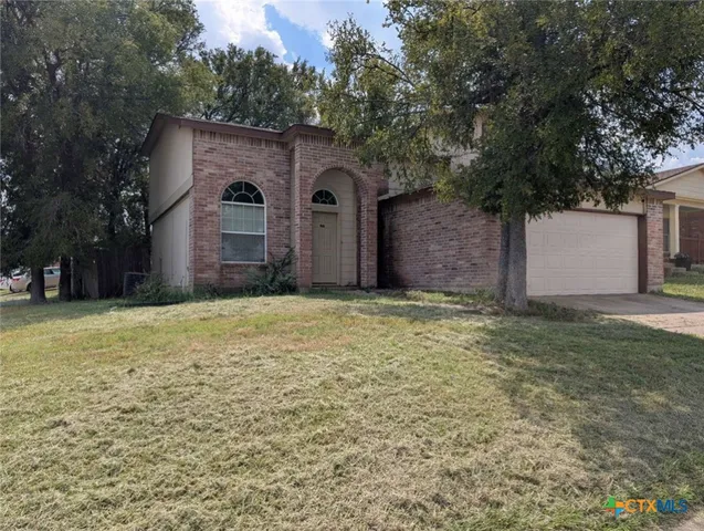 a house that has a tree in front of it