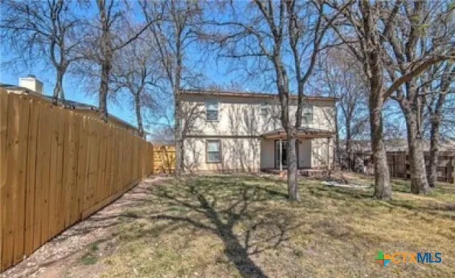 a backyard of a house with lots of green space