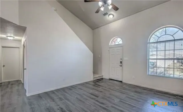 wooden floor in an empty room with a window
