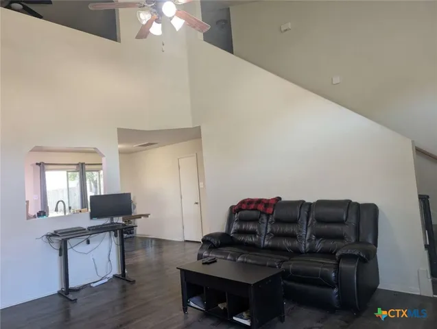 a living room with furniture and a wooden floor
