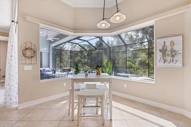 a view of a dining room with furniture large windows and wooden floor