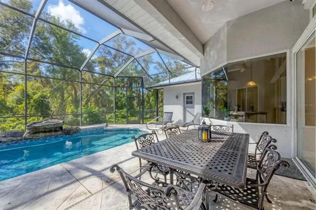 a view of a patio with table and chairs and potted plants