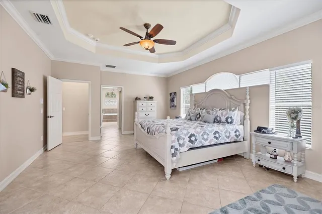 a bedroom with a bed and ceiling fan