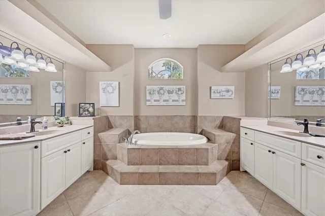 a spacious bathroom with a double vanity sink and a mirror