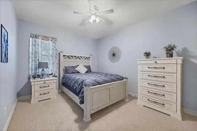 a bedroom with a cabinets and a dresser