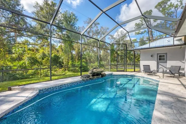 a swimming pool with outdoor seating and yard