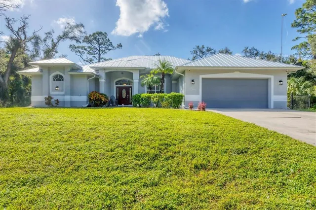 a view of a house with a yard and garage