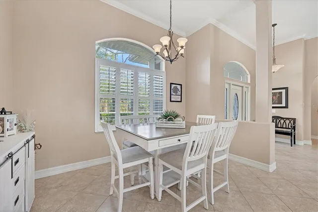 a view of a dining room with furniture and chandelier
