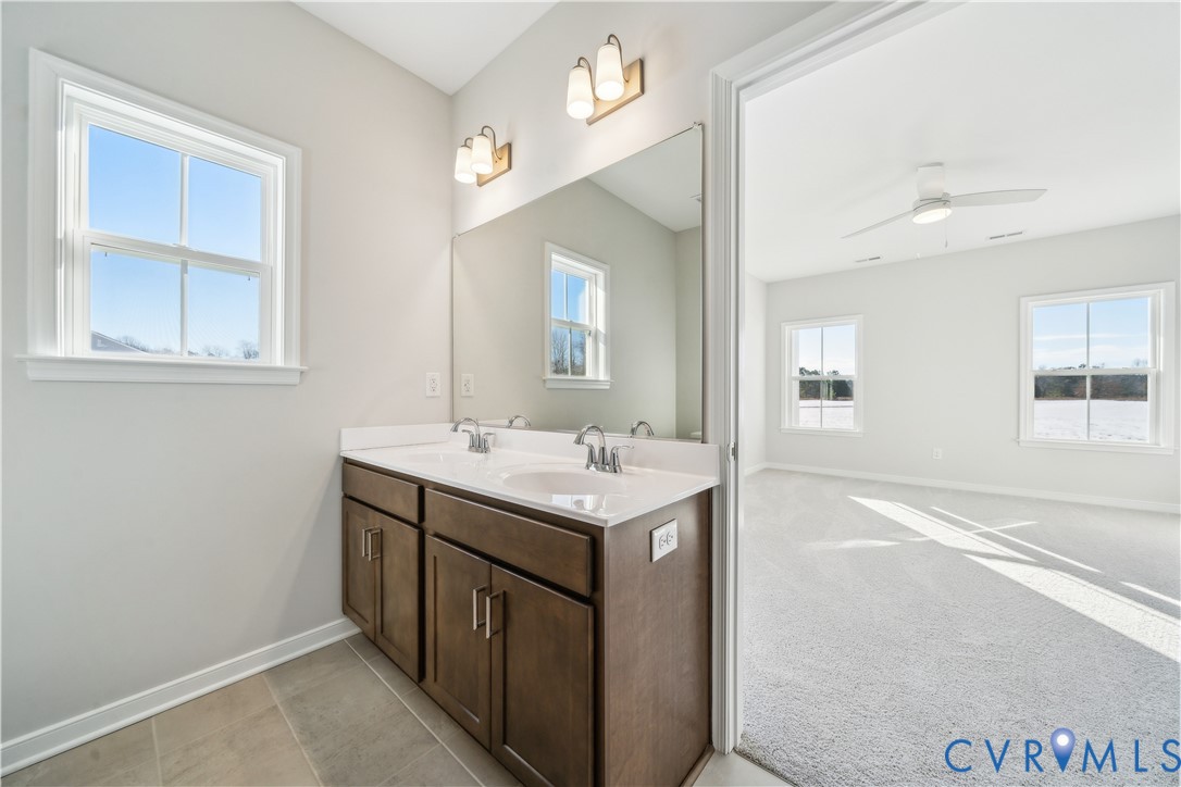 115 Logan Way Tappahannock, VA 22560 - Photo 19 of 29 a bathroom with a sink vanity and a mirror
