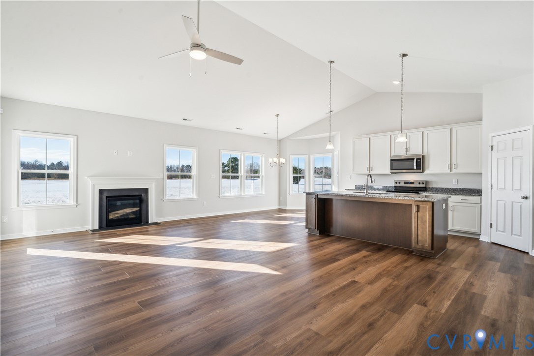 115 Logan Way Tappahannock, VA 22560 - Photo 2 of 29 a kitchen with kitchen island a sink stainless steel appliances and cabinets