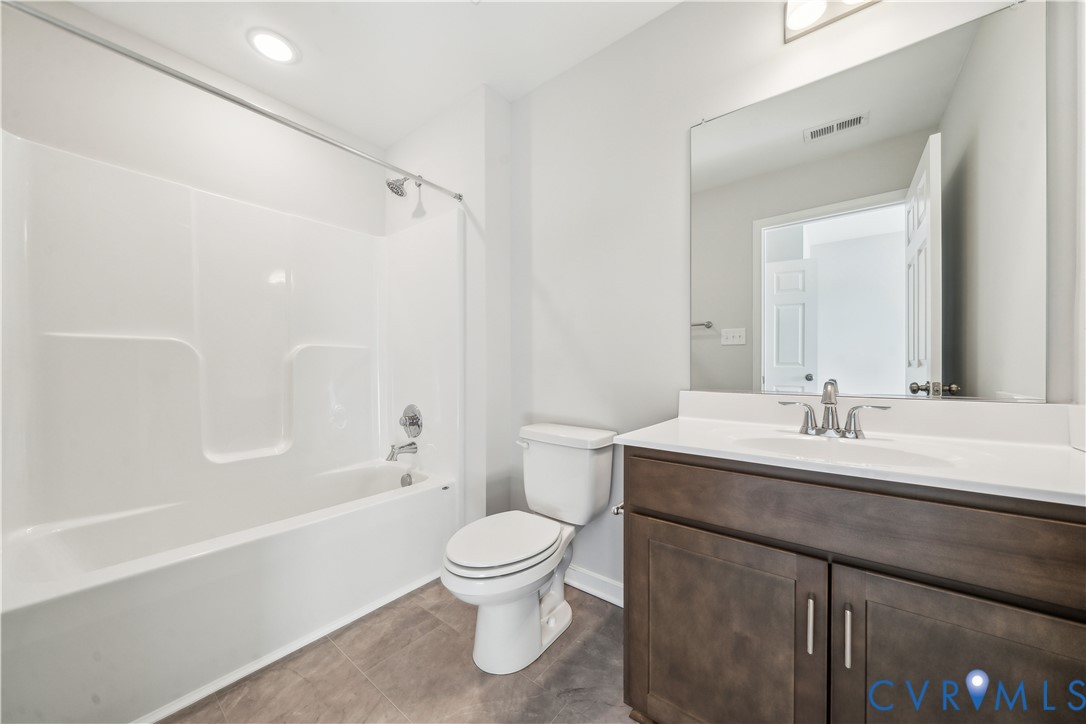 115 Logan Way Tappahannock, VA 22560 - Photo 25 of 29 a bathroom with a sink a toilet and shower