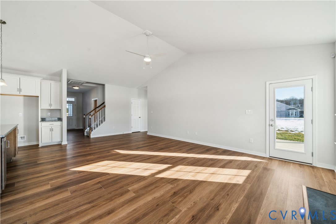 115 Logan Way Tappahannock, VA 22560 - Photo 4 of 29 a view of empty room with wooden floor and a kitchen