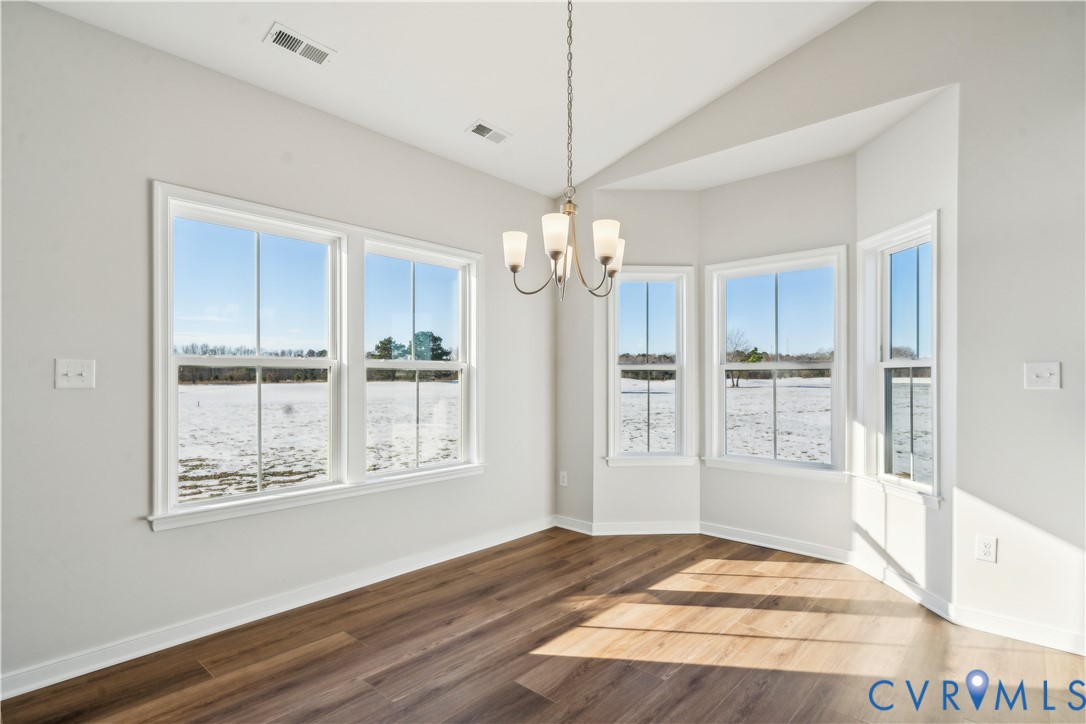 115 Logan Way Tappahannock, VA 22560 - Photo 5 of 29 a view of an empty room with wooden floor and a window