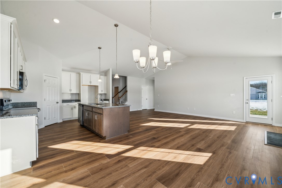 115 Logan Way Tappahannock, VA 22560 - Photo 6 of 29 a view of a kitchen with kitchen island stainless steel appliances wooden floor and living room view
